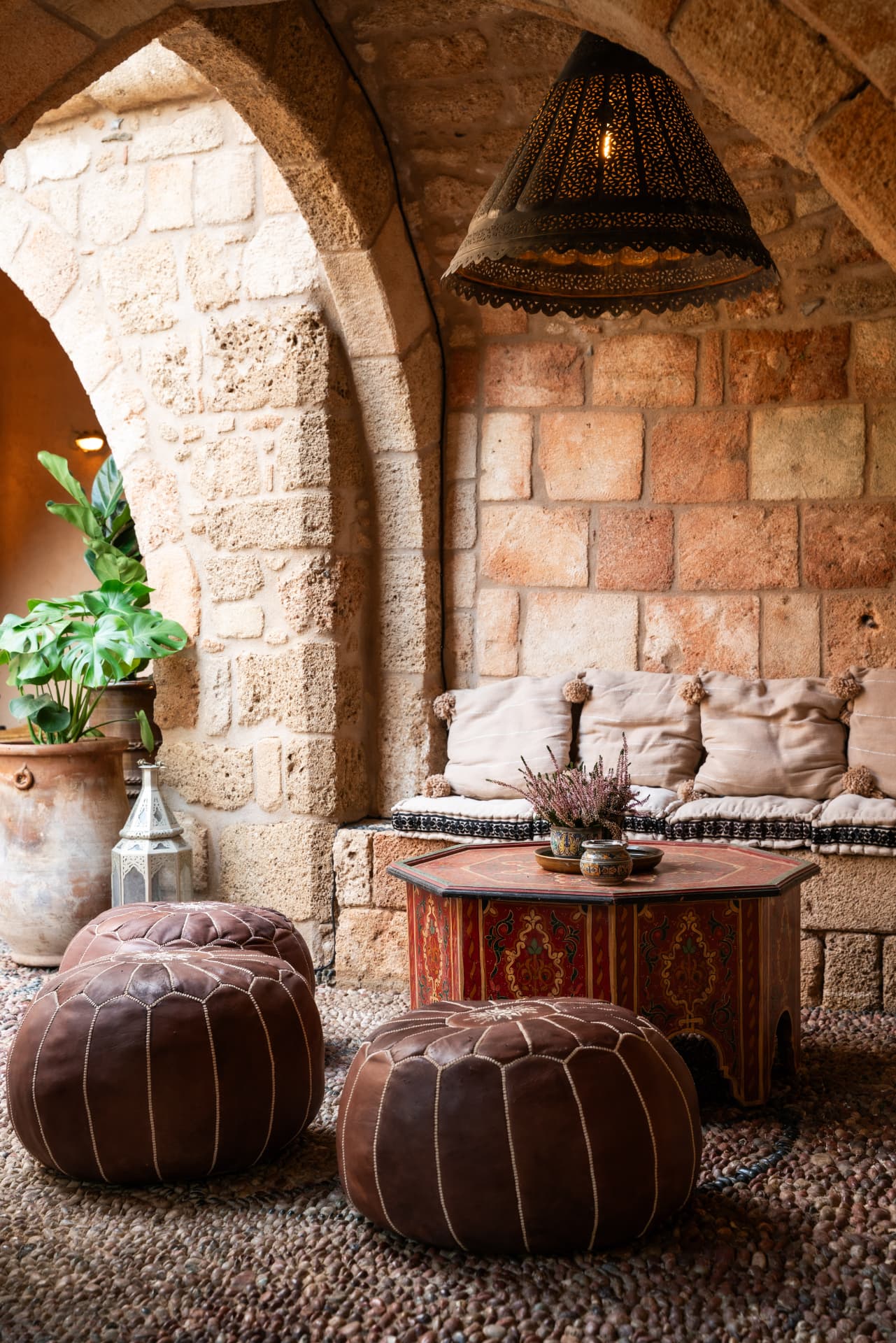 Historic stone arches and traditional seating inside Vasilikos Mansion