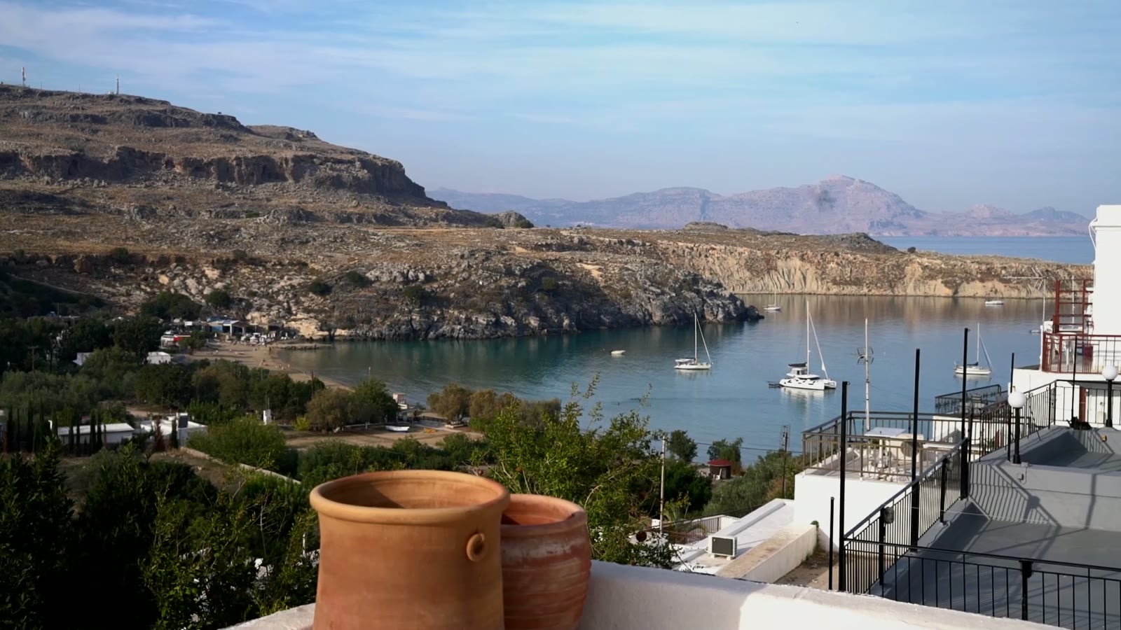 Aegean bay and moored boats viewed from a terrace at Vasilikos Mansion