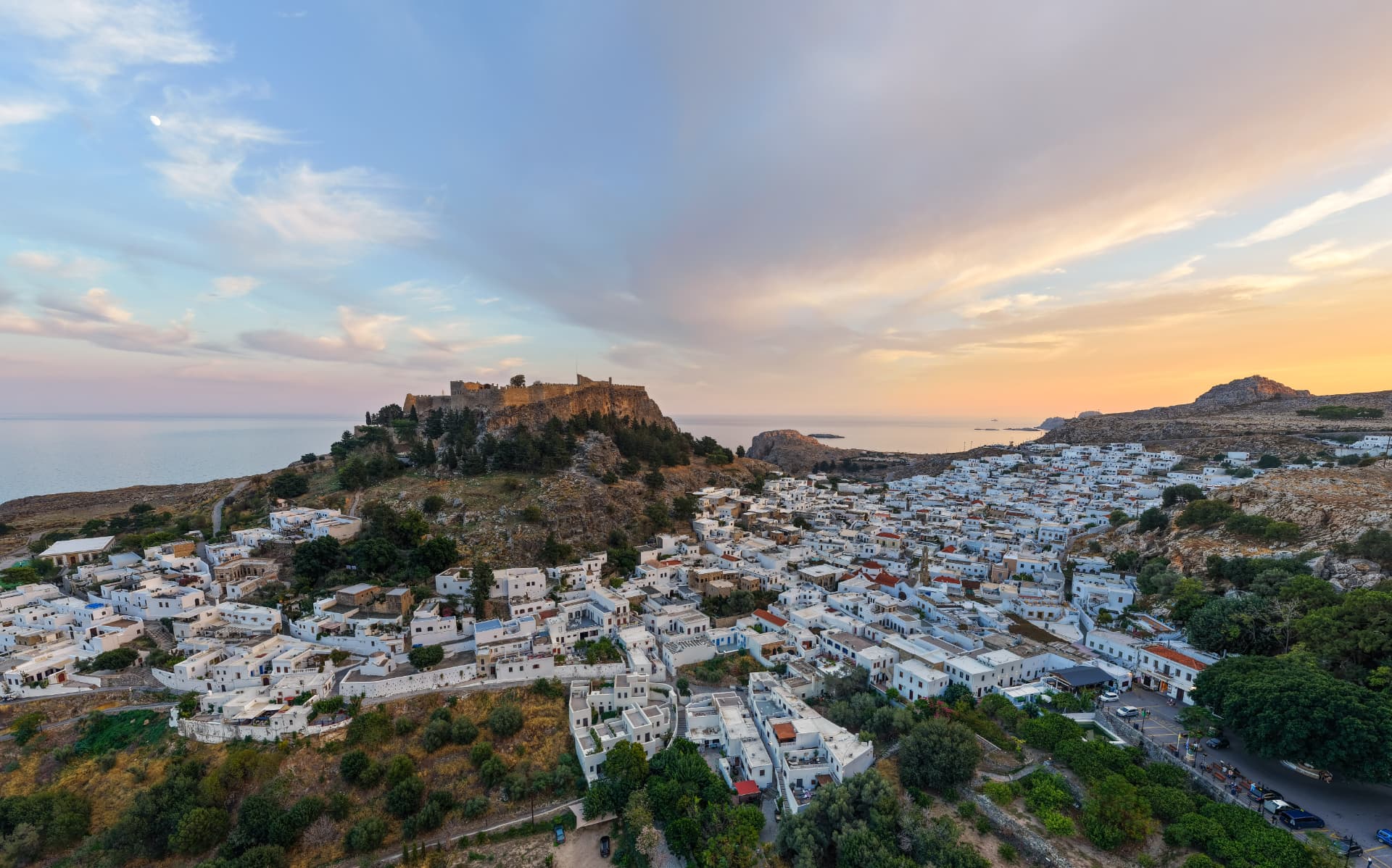 Lindos village and Acropolis above the Aegean at sunrise